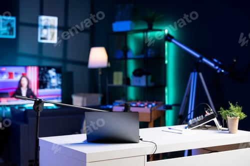 Preview: Empty home studio interior illuminated with neon lights at night, used for internet video production