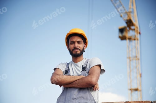 Preview: Portrait of handsome Indian man that is on the construction site