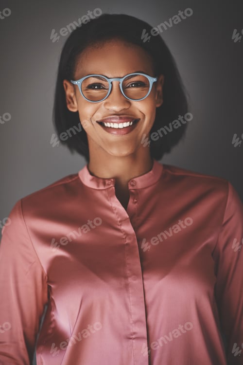 Preview: Young African businesswoman smiling confidently against a gray background