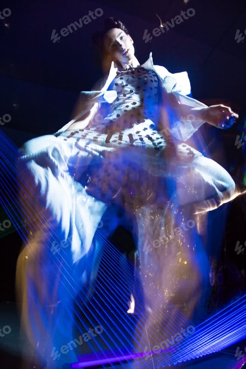 Preview: Fashion model in fashionable clothes in ultraviolet light