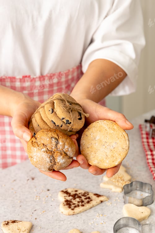 Preview: Homemade cookies in female hands, Christmas baking concept.