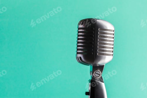 Preview: Vintage microphone on a solid turquoise background during a music recording session