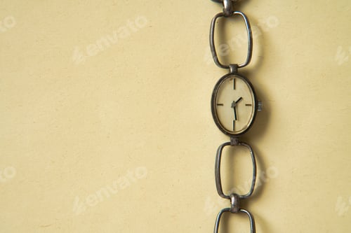 Preview: Vintage clock on a pastel yellow background with space for copy.
