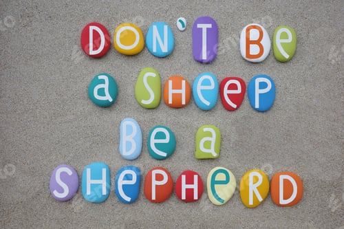 Preview: Do not be a sheep, be a shepherd, creative quote composed with multi colored stone letters over beac