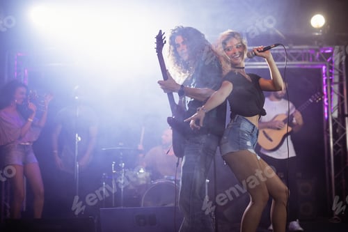Preview: Female singer with male guitarist performing at nightclub