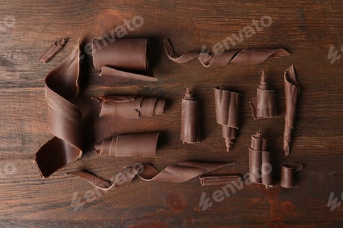 Preview: Chocolate curls on wooden background, flat lay