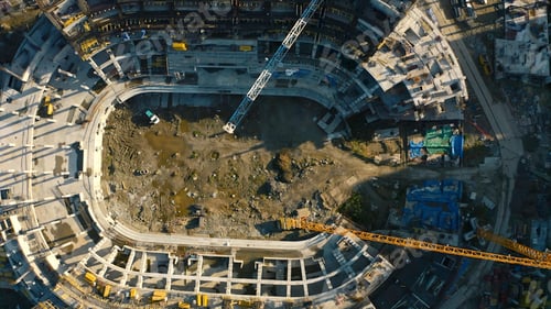 Preview: Vertical top view of construction of circular building. Stock footage. Construction site of building