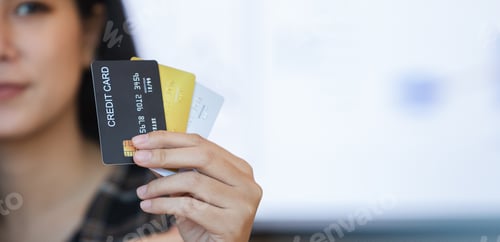 Preview: Female holding credit card. Beautiful smiling showing credit card to online payment.