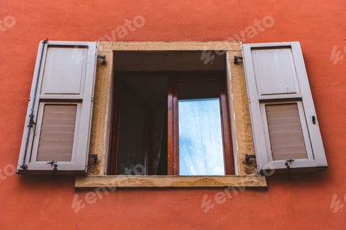 Preview: Open window of a house building with orange walls home
