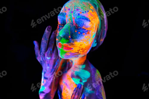 Preview: Portrait of a model with fluorescent makeup posing in UV light with colorful makeup