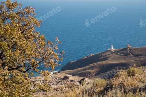 Preview: Small white lighthouse on the seashore. Nice sea view.