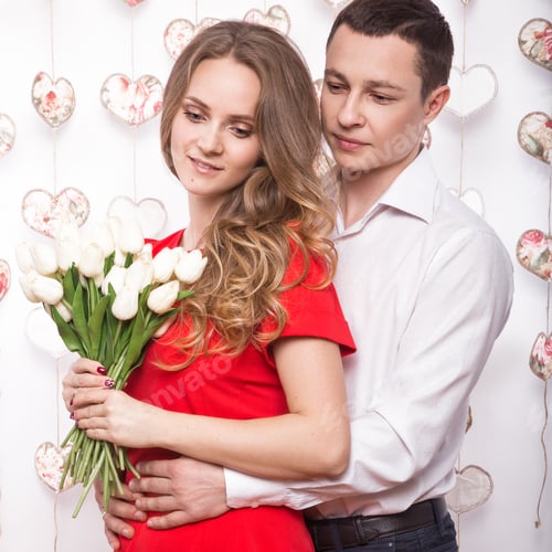 Preview: Beautiful young couple in love with a bouquet of flowers. Valentine's Day.