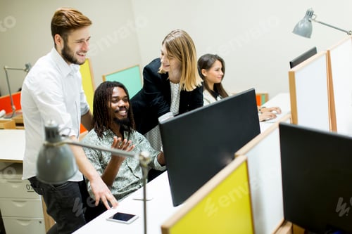 Preview: Young business people in modern office