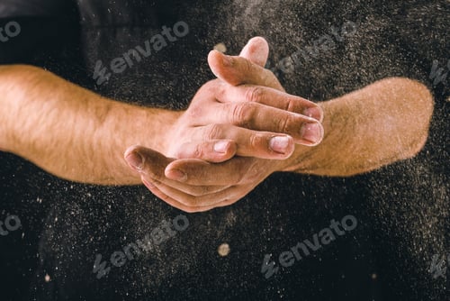 Preview: hand clap and white flour on black background