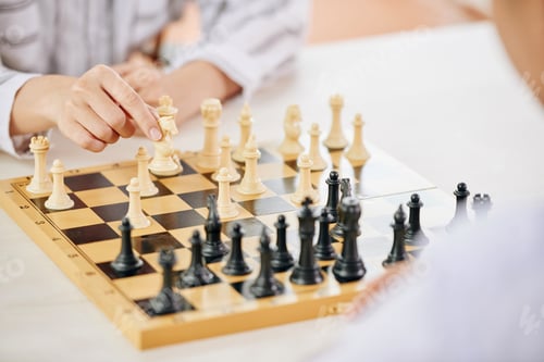 Preview: People playing chess game at table