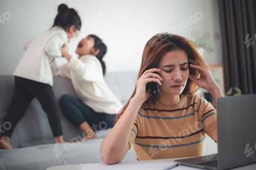 Preview: Home office. Working from home vs. Mom with two kids Work on the Internet on a laptop at home.