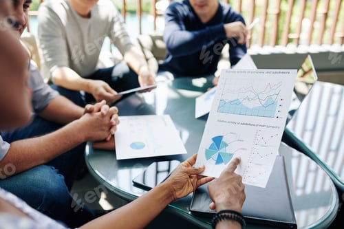 Preview: Entrepreneur discussing report with colleagues