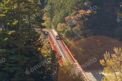 Preview: The steam train crossing Oigawa Railroad to go to station and blue river, The red bridge in Japan