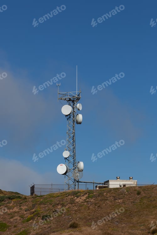 Preview: Vertical shot of a microwave relay telecom radio antennas on a mountain top tower during daylight