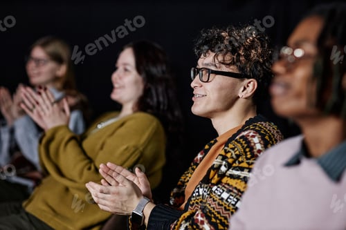 Preview: Diverse Group of Young Adults Applauding during Presentation in Auditorium
