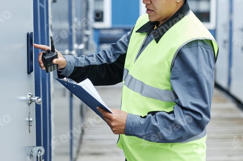 Preview: Worker entering key code on storage unit