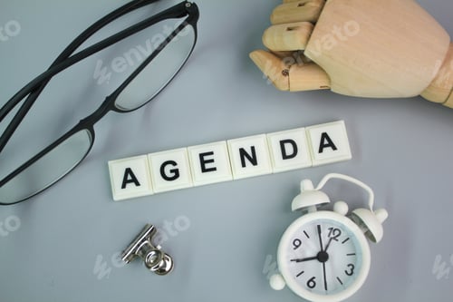Preview: glasses, bell clock and wooden hand with the word agenda