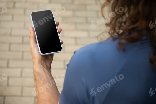 Preview: Man using mobile phone at modern city. Outdoors.