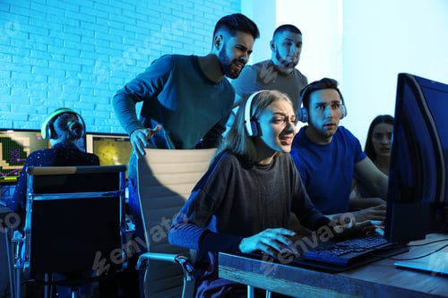 Preview: Young people playing video games on computers indoors. Esports tournament