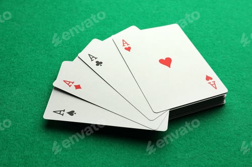 Preview: Four aces playing cards on green table, closeup. Poker game