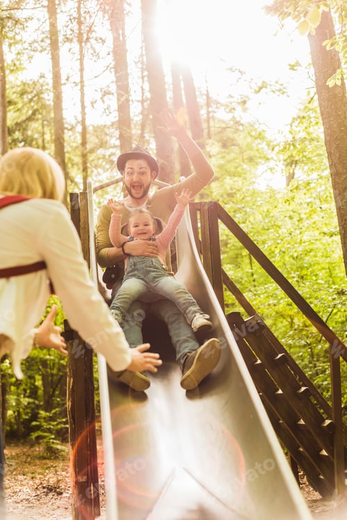 Preview: Happy girl with father on a slide