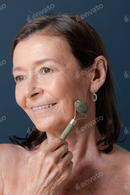 Preview: Elderly woman using a jade roller