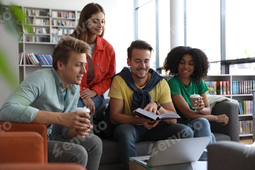 Preview: Group of young people studying at table in library