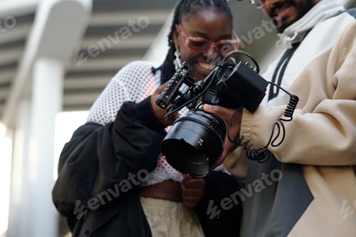 Preview: Smiling Couple Interacting with Professional Camera