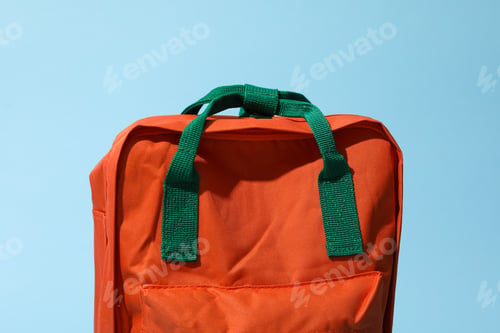 Preview: Concept of school education with backpack on blue background