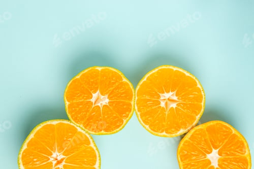 Preview: top view fresh tangerine slices lined on light-blue background color orange fruits citrus