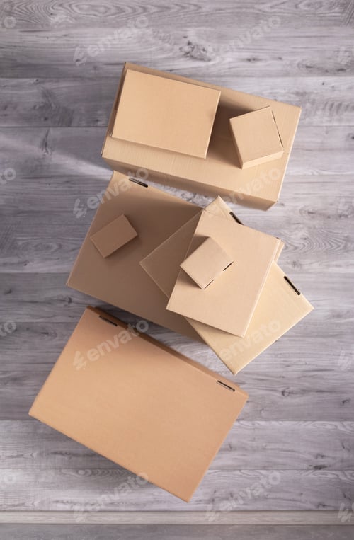 Preview: Stack of cardboard box on floor laminate background. Cardboard boxes for moving to new home