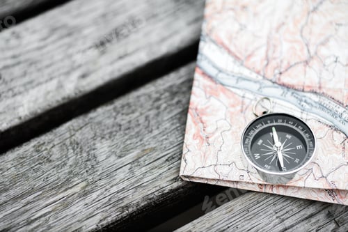 Preview: Compass and map on a beautiful wooden surface. Top view
