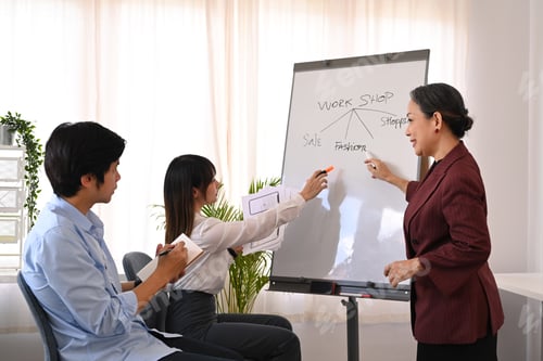 Preview: Confident senior female project leader giving business presentation, explaining marketing data