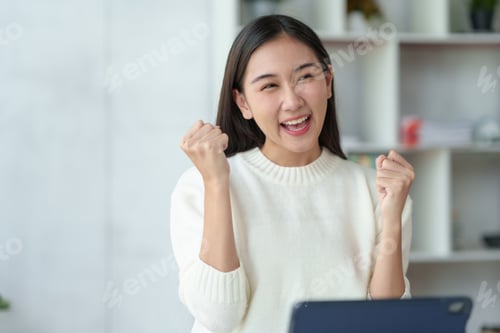 Preview: Pretty young Asian businesswoman sitting on a laptop Glad that the work came out,