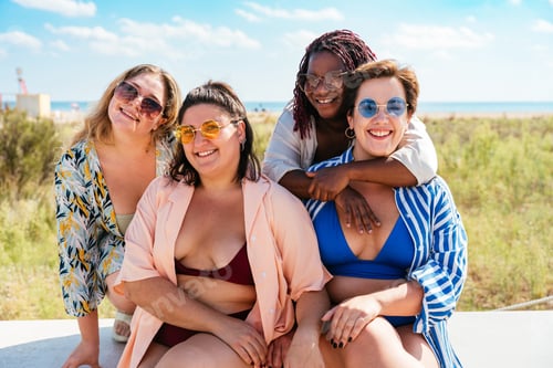 Preview: Group of plus size women with swimwear at the beach
