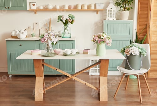 Preview: Crockery and cutlery on the table. Bright kitchen interior. kitchen utensils