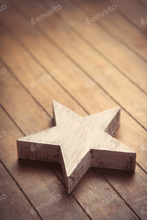 Preview: beautiful star shaped toy lying on the wonderful brown wooden background