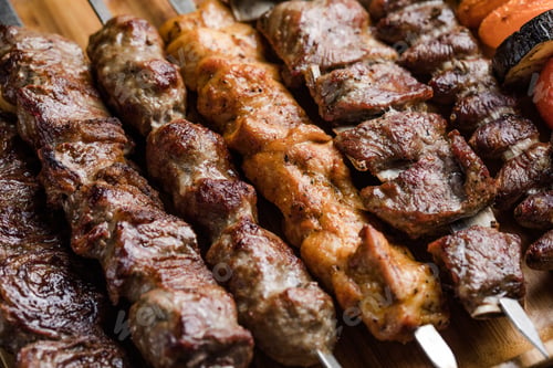 Preview: Marinated shashlik preparing on a barbecue grill over charcoal. Shashlyk (skewered meat) was origina