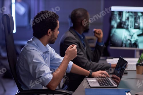 Preview: Two men looking at screen during meeting in IT security office