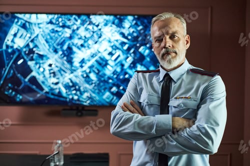 Preview: Portrait of Middle Aged Man Standing Confidently in Front of Map Screen