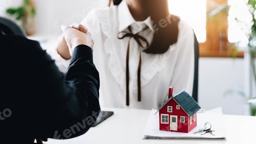 Preview: Agent and customer meeting and handshaking after good deal for buy house. Agreement and Real estate