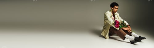 Preview: A portrait of elegance: man with flowers on a grey background