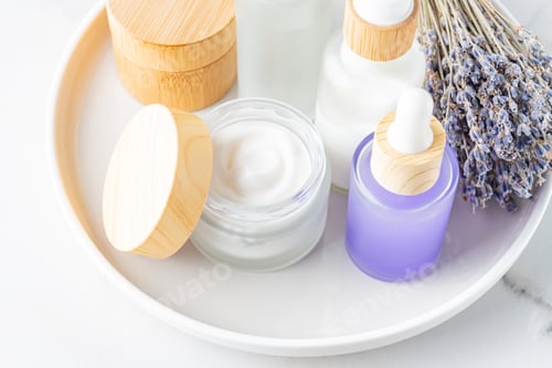 Preview: Lavender spa. Bunch of flowers body cream and essential oil. Natural herbal cosmetics with lavender