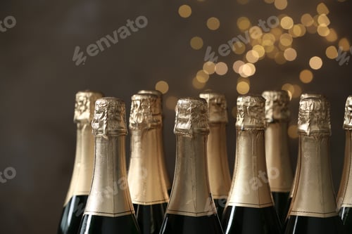 Preview: Many bottles of champagne on blurred background, closeup