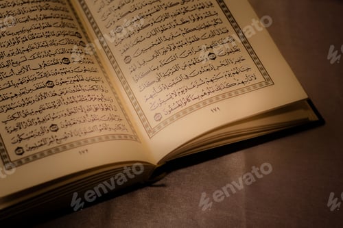 Preview: Open page of the holy Al-Quran book on a wooden prayer mat